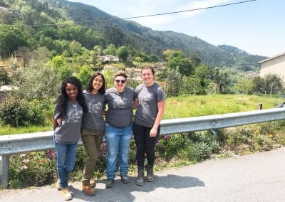 Four Penn State students from different campuses with a bucolic view from the place we ate lunch every day while building the home.